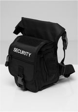 En svart B Security Sidekick Bag med vit 'SECURITY'-text på framsidan, fotograferad mot en ljus bakgrund.